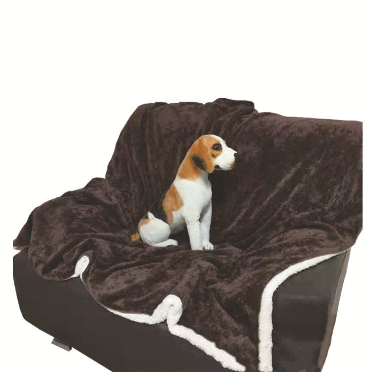 Dog sitting on BarkMiles waterproof travel blanket on a couch